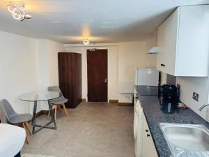 a kitchen with a table and a counter top at Hotels 24-7 - The Old Victoria Hotel in Newport