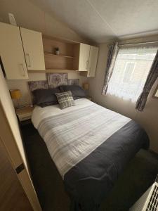 a bedroom with a large bed in a small room at Nockys nook in Filey