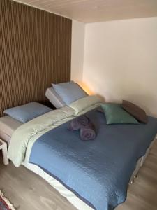 a bed with two pillows on top of it at AdelgadeHuset in Bogense