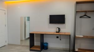 a room with a desk with a tv on a wall at Semih Otel in Erzurum