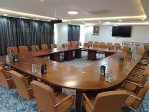 a conference room with a large wooden table and chairs at Blue sky hotel in Oran