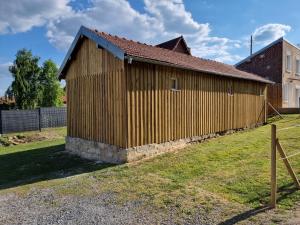 a wooden building with a fence around it at La Germaine in Ribécourt
