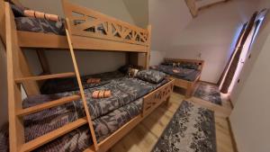 a room with two bunk beds and a staircase at Villa Old Town Vlašić in Šišava