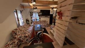 a room with a couch and a table and a wall at Villa Old Town Vlašić in Šišava