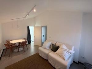 a living room with a white couch and a table at Casa Anna in Mestre
