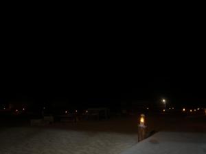 a light in the middle of the beach at night at Wadi Rum Mohammed Camp in Wadi Rum