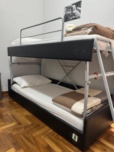 two bunk beds in a room with a wooden floor at Destination In Rome in Rome