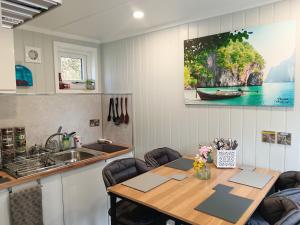 a kitchen with a wooden table and a sink at Garden Guesthouse, Sleep4, Private Entrance, Parking, Wifi, AirCon, Derby City in Derby