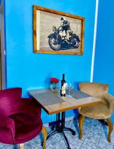 a table with two chairs and a bottle of wine at Villa Đuričić 200m od mora in Đenovići