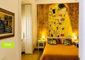 a bedroom with a bed with a painting on the wall at RarityArt GuestHouse in Salerno