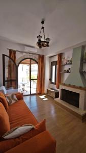 a living room with a couch and a fireplace at Anemi in Kamilari