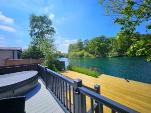 a deck with a view of a lake at Still Waters Luxury Retreat with Hot Tub -Tattershall Lakes in Tattershall