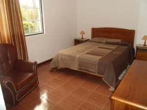 A bed or beds in a room at Tropical Fruit Garden