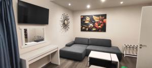 a living room with a couch and a flat screen tv at Anna's Apartments and Studios - Planespotter's Paradise!!! in Corfu Town