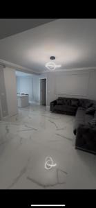 a large room with a white floor and a white ceiling at Adu Luxuri apartament in Rădăuţi +3 photos