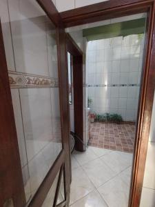 a glass door leading into a bathroom with a toilet at Sobrado 4 km do Shopping Iguatemi, Parque Germânia e Hosp Conceição in Porto Alegre +36 photos