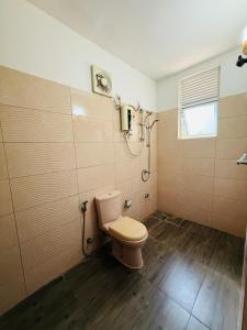 a bathroom with a toilet and a window at Ranmin Eco Village in Kataragama
