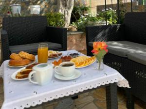 a table with breakfast foods and drinks on it at Villa Agur Kapo in Ksamil
