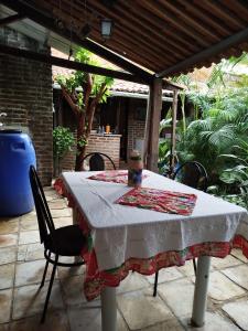 a table with a table cloth on a patio at O Candeeiro - Hostel Acampamento in Arcoverde