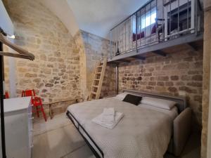 Ένα ή περισσότερα κρεβάτια σε δωμάτιο στο DAMA