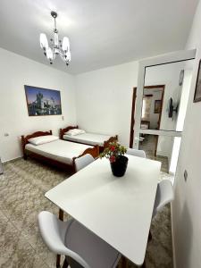 a room with a table and a bed and a mirror at Chris apartament 2 in Polisi i Vogël +4 photos