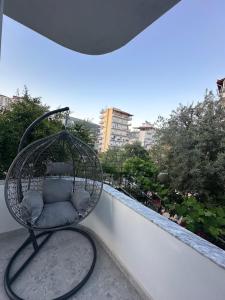 a chair sitting on top of a balcony at Chris apartament 2 in Polisi i Vogël