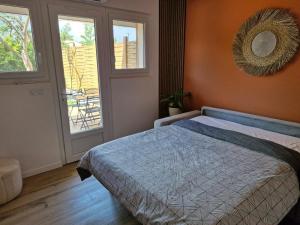 a bedroom with a bed and a mirror on the wall at Maison St Aygulf entre mer et détente in Fréjus