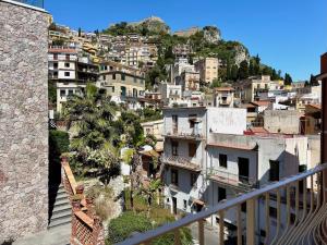 a view of a city from a balcony at Poet's rooms in Taormina
