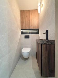 a bathroom with a white toilet and a sink at Duchesse Luxe Cap - Naturiste in Cap d'Agde +31 photos