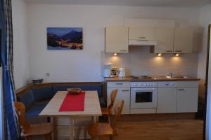 a kitchen with a table and a table and chairs at Haus Salzburgerland in Altenmarkt im Pongau