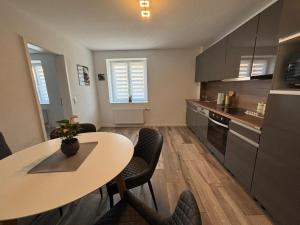 a kitchen with a table and chairs in a room at Grenznahe Ferienwohnung in Grenzach-Wyhlen in Grenzach-Wyhlen