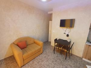 a living room with a couch and a table at Airport view Apartment in Belgrade