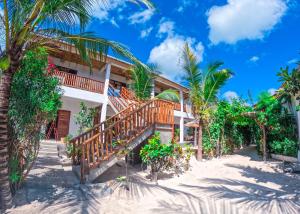 a resort on the beach with palm trees at Ananda Beach Hotel in Paje