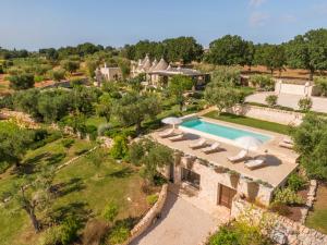 an aerial view of a villa with a swimming pool at CANTALANOTTE Luxury Trulli Resort in Cisternino