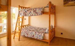 two bunk beds in a room with a ladder at Happy Waves Morocco in Taghazout +26 photos