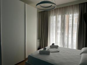 a bedroom with a bed and a large window at LARIMAR Lungomare Vlore in Vlorë