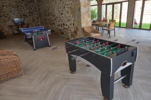 a ping pong table in a room with a foos ball at Casa Rural La Botica de la Tía Paqui in Villanueva del Duque
