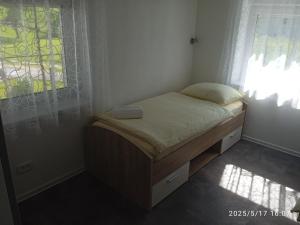 a small bed in a room with a window at Apartment One2one in Bovec