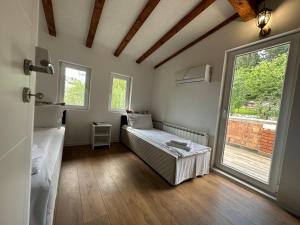 a small room with a bed and a window at Villa IMAN in Sarajevo