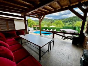 a living room with a table and a pool at Villa IMAN in Sarajevo