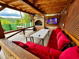 a living room with a red couch and a table at Villa IMAN in Sarajevo