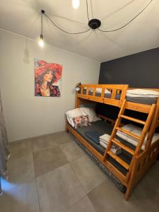 a bedroom with two bunk beds and a painting at Domki La Bella 2 in Aleksandria