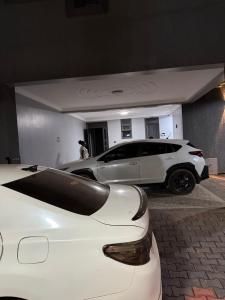 a white car parked in front of a garage at Mirenbe apartments in Nalakonge