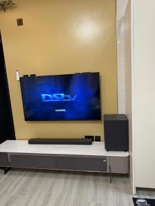 a flat screen tv hanging on a wall at Mirenbe apartments in Nalakonge