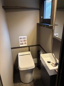 a small bathroom with a toilet and a sink at Panoramahytte med utsikt mot Eggenipa in Egge +24 photos