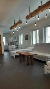 a room with a large bed and a wooden table at Pension Fontána Svitavy in Svitavy