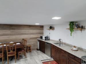 a kitchen with a table and a dining room at Belo Encanto do Paiva in Castelo de Paiva