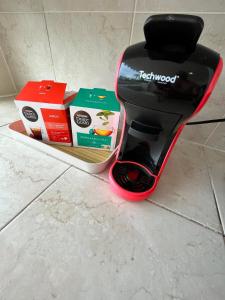 a black and red blender sitting on a counter with boxes at Appartement Rénové avec accès piscine Superbe VUE MER Village de vacances de Sainte-Anne Guadeloupe OCEAN LILI's EYES in Sainte-Anne +90 photos