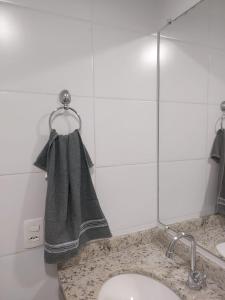 a bathroom sink with a towel hanging on a ring at Apto 2dormitórios Empresa família CentroBrás in Sao Paulo +36 photos