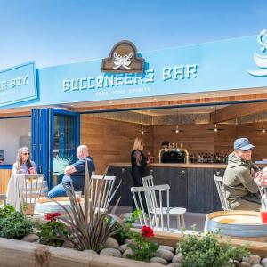 a group of people sitting outside of a restaurant at marine getaways caravan hire in Rhyl